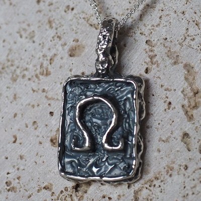 The Bespoke Omega Pendant, a sterling silver tablet pendant with an omega symbol