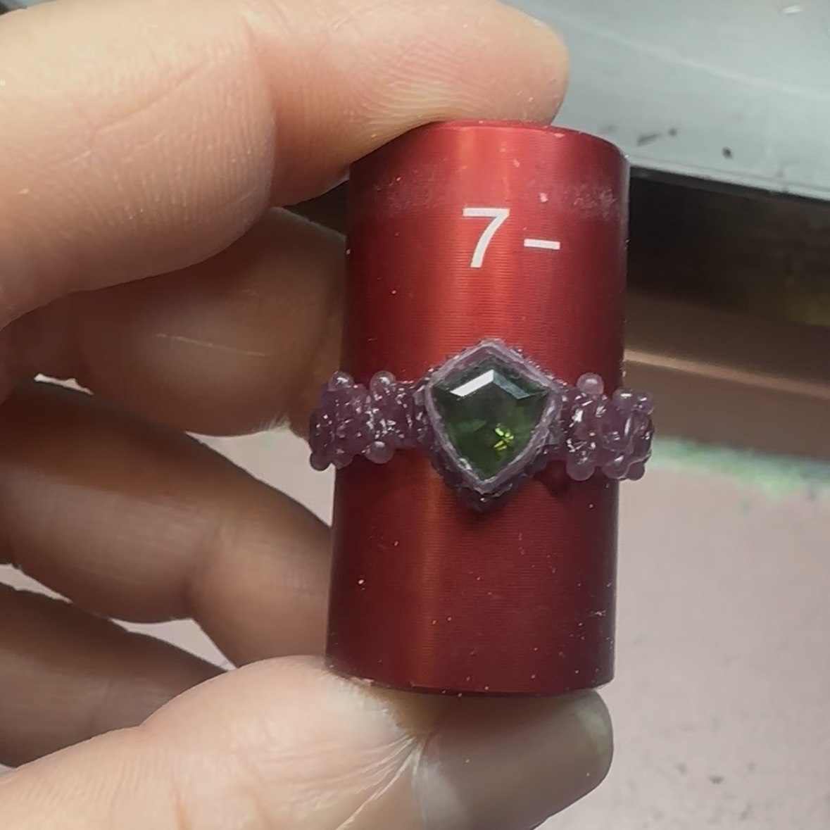 A tourmaline ring setting shown in wax on a mandrel before casting